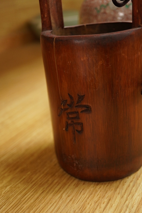 A Chinese famille rose jardiniere and bamboo oak rail, famille rose jardiniere 27cm diameter. Condition - jardiniere cracked from rim and restored, bamboo side cracked